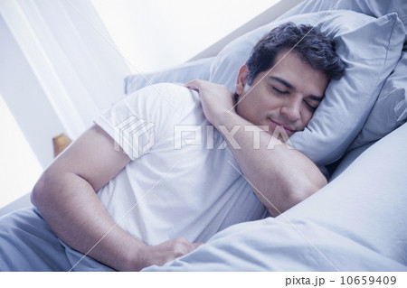 Portrait of young man sleeping in bed Portrait of young man sleeping in bed 10659409