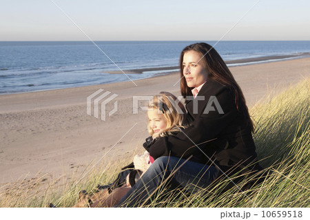 Netherlands, Zeeland, Haamstede, Mother with daughter on beach 10659518