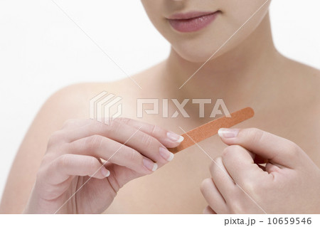 Beauty shot of woman using nail file Beauty shot of woman using nail file 10659546