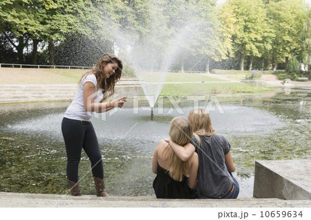 Female friends using cell phone 10659634