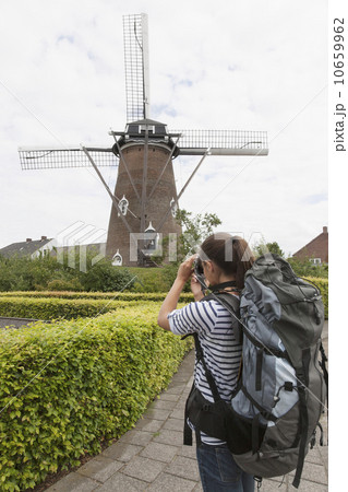 Woman photographing windmill 10659962