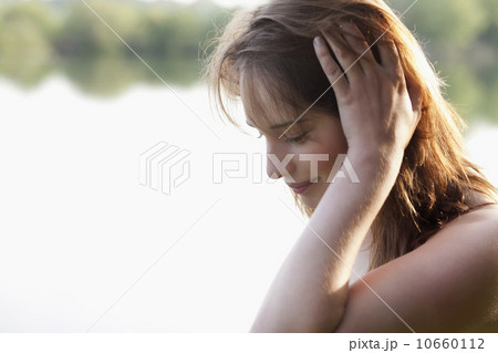 Young woman running head through hair 10660112