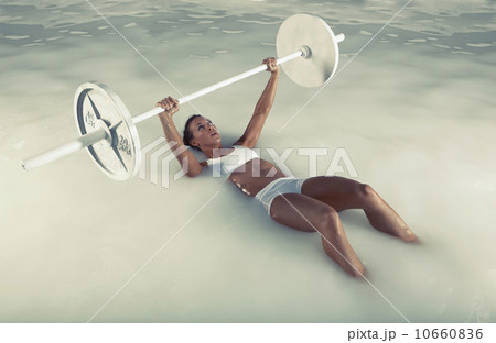 Young woman weight lifting in water Young woman weight lifting in water 10660836