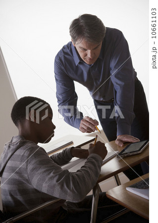Teenage boy (14-15) with teacher at school Teenage boy (14-15) with teacher at school 10661103