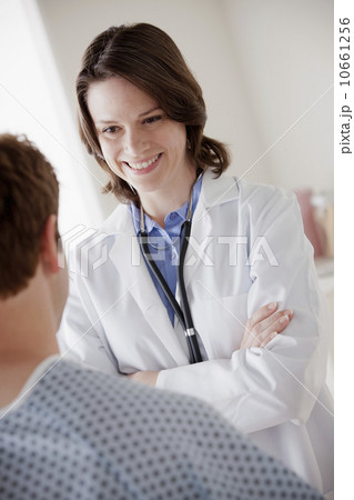 Smiling doctor talking with patient Smiling doctor talking with patient 10661256