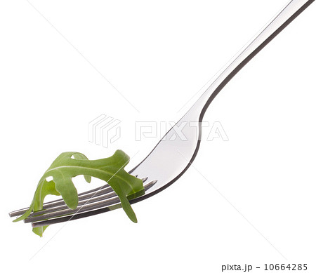 Fresh rucola salad on fork isolated on white background cutout. Fresh rucola salad on fork isolated on white background cutout. 10664285