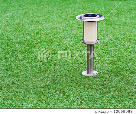 Solar-powered lamp on garden background. 10669098