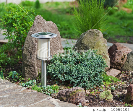 Solar-powered lamp on garden background. Solar-powered lamp on garden background. 10669102