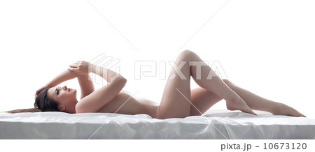 Sexy young brunette posing nude, lying in studio 10673120