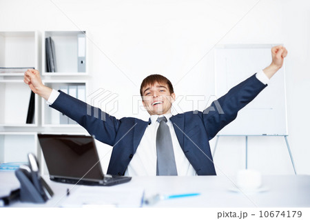 Relaxed happy young business man after working at the office 10674179