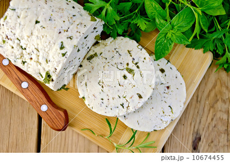 Cheese homemade with herbs and knife on board 10674455