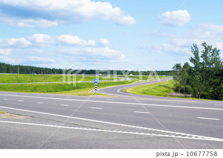 Road, gren grass and blue sky 10677758