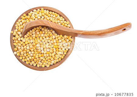 yellow peas (cereals) in the bowl with wood spoon over white 10677835