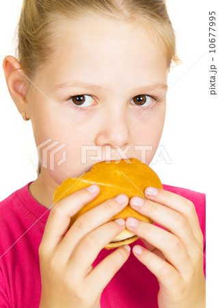 Happy Little Girl Eating Hamburger. 10677995