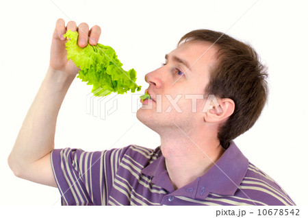 The young man is appetizing eats green salad The young man is appetizing eats green salad 10678542