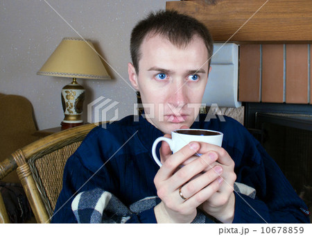 A man drinking from white cup 10678859