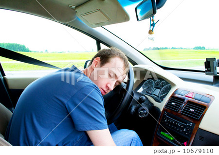 man sleeps in a car 10679110