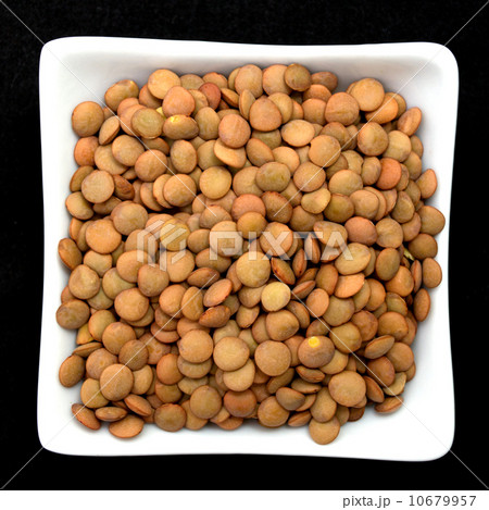 lentil in a white bowl isolated on black lentil in a white bowl isolated on black 10679957