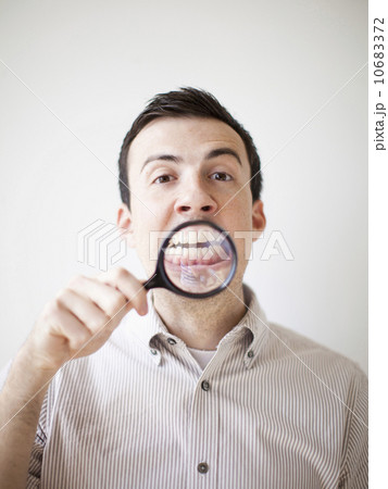 Man looking standing looking through magnifying glass Man looking standing looking through magnifying glass 10683372