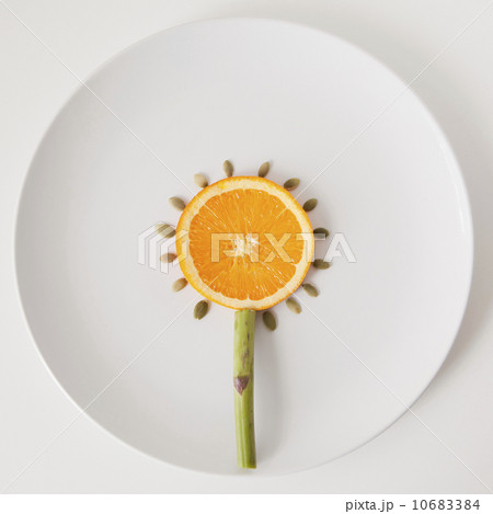 Sunflower made out of food on plate, studio shot Sunflower made out of food on plate, studio shot 10683384