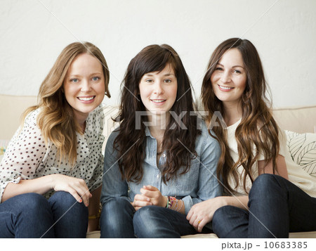 Three young female friends sitting on sofa Three young female friends sitting on sofa 10683385