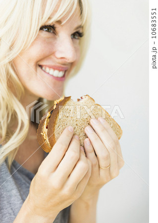 Woman eating sandwich with peanut butter Woman eating sandwich with peanut butter 10683551