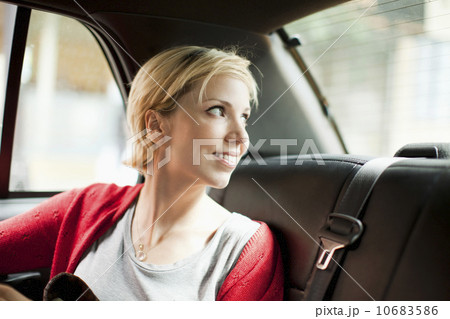 Woman sitting in back seat of car Woman sitting in back seat of car 10683586
