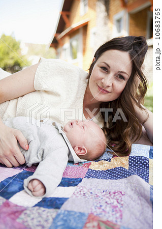 Young mother with baby boy ( 2-5 months) lying on blanket 10683765