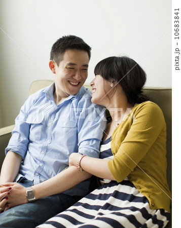 Young happy couple sitting on sofa 10683841