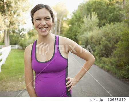 Front view portrait of pregnant mid adult woman in sport clothing Front view portrait of pregnant mid adult woman in sport clothing 10683850