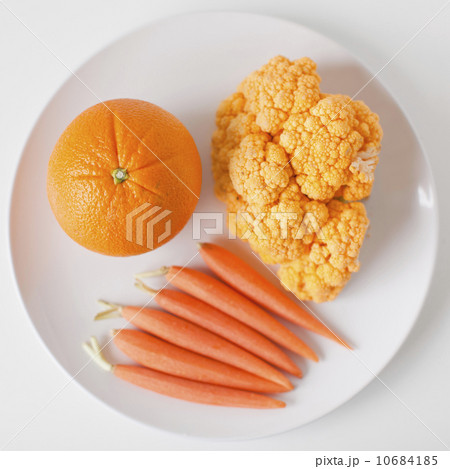 Orange fruits and vegetables on plate Orange fruits and vegetables on plate 10684185