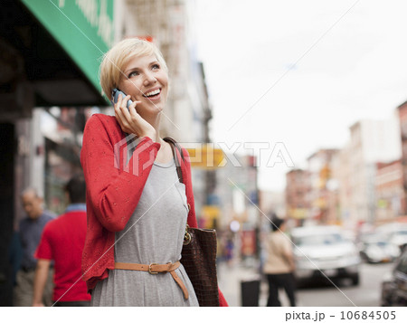Woman smiling and talking on phone Woman smiling and talking on phone 10684505