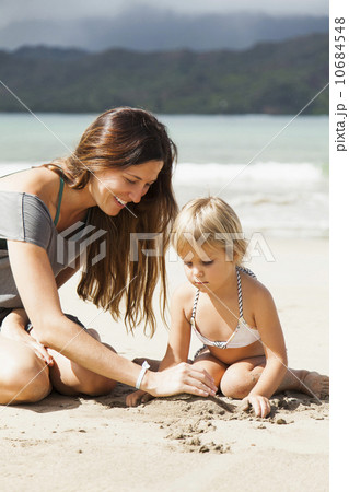 Mother playing with daughter (2-3) on beach 10684548