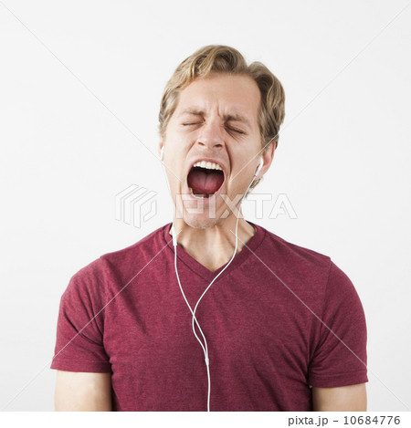 Man singing while listening to music 10684776