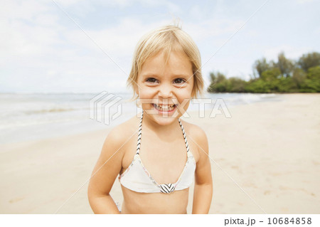 Smiling girl (2-3) on sandy beach 10684858