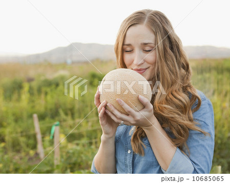Portrait of young woman holding cantaloupe 10685065