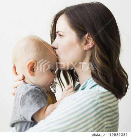 Studio portrait of mother kissing baby boy (6-11 months) 10685085