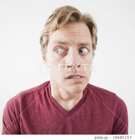 Studio Shot of mid adult man expressing fear with eyes wide open 10685157