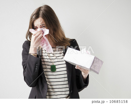 Studio shot of young woman sneezing 10685158
