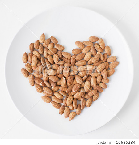 Almonds heart on plate, studio shot Almonds heart on plate, studio shot 10685234