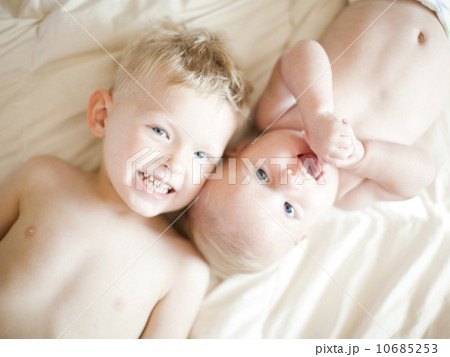 Portrait of boy (2-3) with baby sister (6-11 months) 10685253