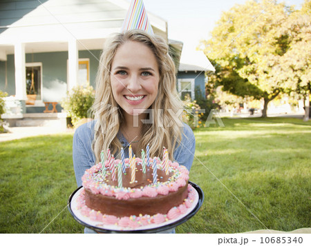 Portrait of young woman holding birthday cake 10685340