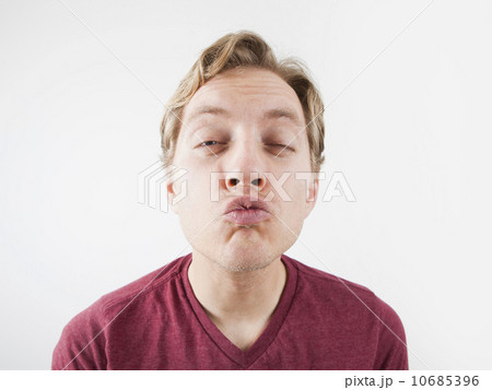Studio Shot of mid adult man puckering Studio Shot of mid adult man puckering 10685396