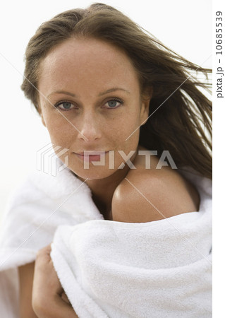 Attractive mid-adult woman wrapped in white towel Attractive mid-adult woman wrapped in white towel 10685539