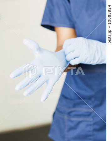 Close-up of nurses hands-putting on surgical gloves 10685924