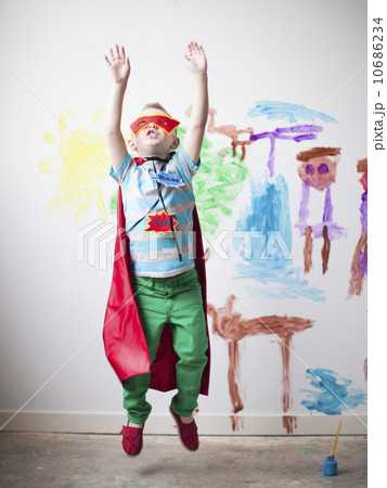 Toddler boy (2-3) in superhero costume jumping mid-air Toddler boy (2-3) in superhero costume jumping mid-air 10686234