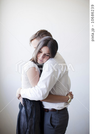 Young couple embracing, studio shot 10686239