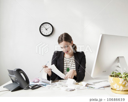 Studio shot of young woman doing paperwork, expressing negativity 10686639
