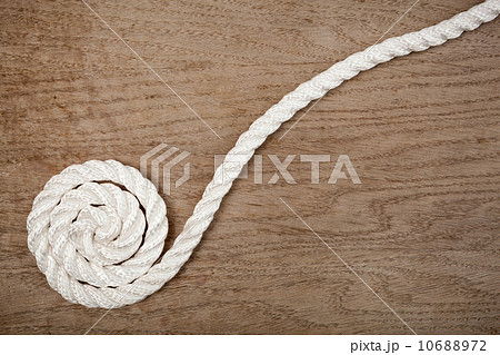 Nylon rope spiral on a wooden background Nylon rope spiral on a wooden background 10688972