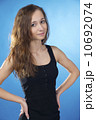 Isolated on blue brunette woman with arms akimbo 10692074